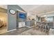 The living area features a large TV and neutral gray walls, open to the kitchen and dining area at 4802 51St W St # 1118, Bradenton, FL 34210
