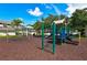 A community playground featuring a swing set, gazebo, and play structure on mulch and grass at 4802 51St W St # 1118, Bradenton, FL 34210