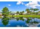 A beautiful pond reflects the community buildings and palm trees at 4802 51St W St # 1118, Bradenton, FL 34210