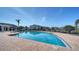 Community pool featuring brick surround and lounge chairs with clear blue skies at 4802 51St W St # 1118, Bradenton, FL 34210
