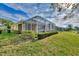 Private screened patio overlooking landscaped yard and lake at 4914 Lakescene Pl, Sarasota, FL 34243