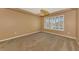 Bright bedroom with neutral walls, carpeting, and large window at 4914 Lakescene Pl, Sarasota, FL 34243