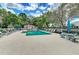 Community pool with lounge chairs and shaded seating at 4914 Lakescene Pl, Sarasota, FL 34243