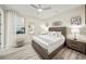 Bright bedroom featuring a king-size bed and wood-look floors at 4947 Surfside Cir, Bradenton, FL 34211