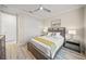 Well-lit bedroom with a queen bed, wood floors, and neutral decor at 4947 Surfside Cir, Bradenton, FL 34211