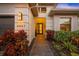 Welcoming entryway with a brick walkway, landscaping, and modern lighting at 4947 Surfside Cir, Bradenton, FL 34211