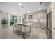 Modern kitchen with white cabinets, center island, and stainless steel appliances at 4947 Surfside Cir, Bradenton, FL 34211