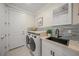 Modern laundry room with washer, dryer, and stylish sink at 4947 Surfside Cir, Bradenton, FL 34211