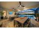 Outdoor entertaining area with covered patio, pool, and lake view at 4947 Surfside Cir, Bradenton, FL 34211
