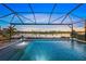 Stunning screened pool with lake view at sunset at 4947 Surfside Cir, Bradenton, FL 34211