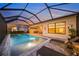 Relaxing pool area with covered patio, lounge chairs, and outdoor seating at 4947 Surfside Cir, Bradenton, FL 34211