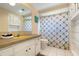 Bathroom featuring a tub shower combo, neutral tile, and ample storage at 5207 Bimini Dr, Bradenton, FL 34210