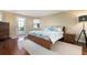 Bedroom featuring a bed with soft linens, hardwood floors, and natural light from door and window at 5207 Bimini Dr, Bradenton, FL 34210