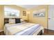 Bright bedroom features a striped quilt and a great view from the large windows at 5207 Bimini Dr, Bradenton, FL 34210