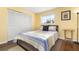 Bright bedroom features a striped quilt and a large closet, creating a cozy retreat at 5207 Bimini Dr, Bradenton, FL 34210