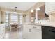 Bright kitchen with white cabinets and appliances overlooking a breakfast nook at 5207 Bimini Dr, Bradenton, FL 34210