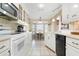 Bright kitchen with white cabinets and appliances overlooking a breakfast nook at 5207 Bimini Dr, Bradenton, FL 34210