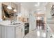 Bright kitchen with white cabinets and appliances, with a passthrough to the dining room at 5207 Bimini Dr, Bradenton, FL 34210