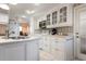 Bright kitchen featuring white cabinetry, stainless steel appliances, and tiled floors at 5207 Bimini Dr, Bradenton, FL 34210