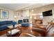 Open floor plan living room features a stone fireplace and pool table beyond at 5207 Bimini Dr, Bradenton, FL 34210