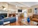 Living room featuring a stone fireplace, a pool table, and an open floor plan at 5207 Bimini Dr, Bradenton, FL 34210