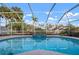 A refreshing pool and jacuzzi awaits with palms overhead in a private, screened-in lanai at 5207 Bimini Dr, Bradenton, FL 34210