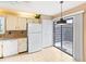 Eat-in kitchen with white appliances and access to a private patio at 5400 34Th W St # D12, Bradenton, FL 34210
