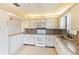 Bright kitchen features white cabinets, tile backsplash, and modern appliances at 5400 34Th W St # D12, Bradenton, FL 34210
