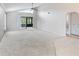 Bright living room with high ceilings, carpet flooring and access to a private patio at 5400 34Th W St # D12, Bradenton, FL 34210