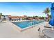 Community pool with lounge chairs and a table, perfect for relaxation at 5400 34Th W St # D12, Bradenton, FL 34210