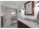 Bathroom with granite countertop, a shower/tub combo, and updated vanity at 543 Hillcrest Dr, Bradenton, FL 34209