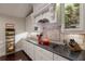 Modern kitchen with dark countertops and white cabinets at 543 Hillcrest Dr, Bradenton, FL 34209