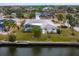 Aerial view of waterfront home and lush landscaping at 5560 Shadow Lawn Dr, Sarasota, FL 34242