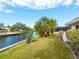 Landscaped backyard with canal views and lush greenery at 5560 Shadow Lawn Dr, Sarasota, FL 34242