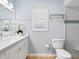 Bathroom with white vanity, quartz countertop, and walk-in shower at 5560 Shadow Lawn Dr, Sarasota, FL 34242