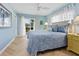 Main bedroom with light blue walls, herringbone floors, and access to patio at 5560 Shadow Lawn Dr, Sarasota, FL 34242