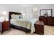 Guest bedroom with wood furniture, and herringbone wood-look flooring at 5560 Shadow Lawn Dr, Sarasota, FL 34242
