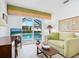 Bright den features a view of the pool and sliding glass doors at 5560 Shadow Lawn Dr, Sarasota, FL 34242