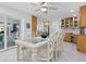 Bright dining area with white table and chairs near kitchen and access to patio at 5560 Shadow Lawn Dr, Sarasota, FL 34242