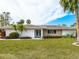 Charming single-story home with stone accents and well-manicured lawn at 5560 Shadow Lawn Dr, Sarasota, FL 34242