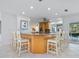 Bright kitchen with island, breakfast bar, stainless steel appliances, and ample cabinetry at 5560 Shadow Lawn Dr, Sarasota, FL 34242