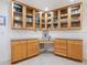 Kitchen features corner desk and glass-front cabinetry offering extra storage at 5560 Shadow Lawn Dr, Sarasota, FL 34242
