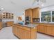 Bright kitchen featuring an island, stainless steel appliances, and ample cabinetry at 5560 Shadow Lawn Dr, Sarasota, FL 34242