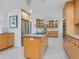 Spacious kitchen boasts wood cabinetry, granite countertops, and stainless steel appliances at 5560 Shadow Lawn Dr, Sarasota, FL 34242