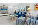 Cozy living room featuring blue striped sofas and a flatscreen TV at 5560 Shadow Lawn Dr, Sarasota, FL 34242