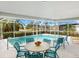 Relaxing pool area with a patio table and chairs at 5560 Shadow Lawn Dr, Sarasota, FL 34242