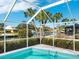 Enjoy the sparkling pool with canal views from this screened enclosure at 5560 Shadow Lawn Dr, Sarasota, FL 34242