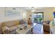 Living room with balcony access and coastal decor at 6033 34Th W St # 120, Bradenton, FL 34210
