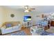 Living room with sofa, TV, and dining area at 6033 34Th W St # 120, Bradenton, FL 34210