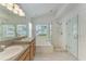 Bathroom with double sinks, soaking tub, and separate shower at 6215 Blueflower Ct, Lakewood Ranch, FL 34202